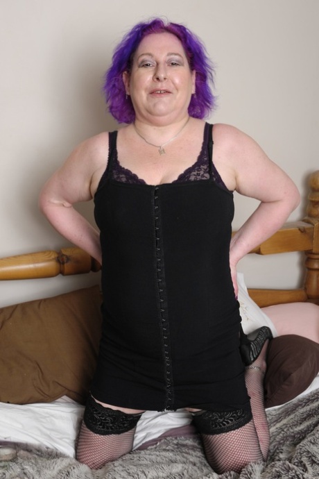Mature with purple hair Nataline shows off her big boobs & plays with tiny toy