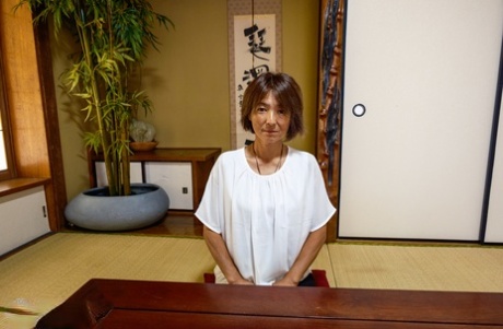 Asian granny Asami Fujiwara strips and facesits a guy on the floor