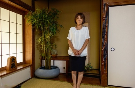 Asian granny Asami Fujiwara strips and facesits a guy on the floor